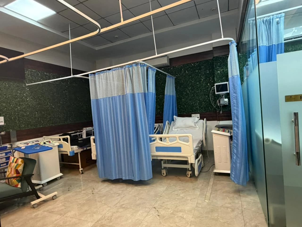 Patient recovery bay at the Art of Healing Cancer centre, with private curtained cubicles